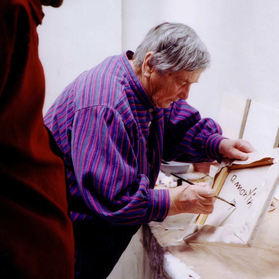agnes Martin signing a painting